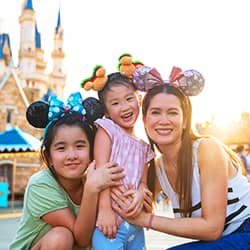 A family wearing Mickey ears at Disney World in Orlando.